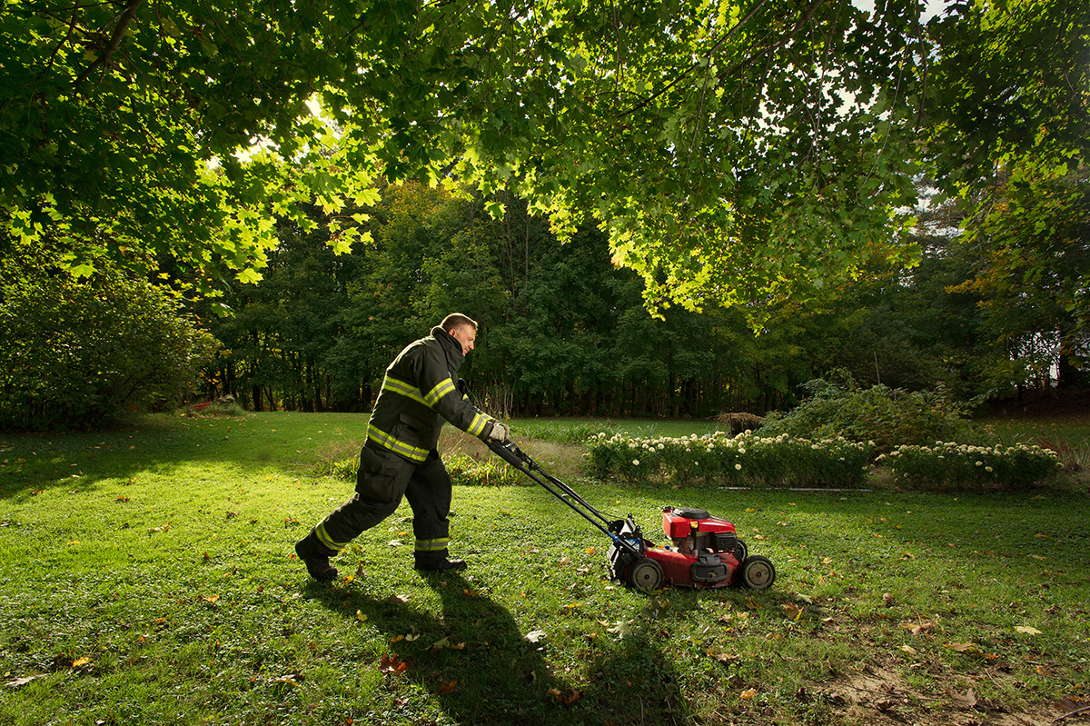 Firefighter mowing